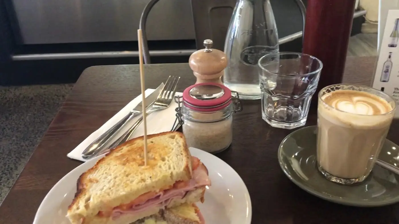 A toasted sandwich with chips